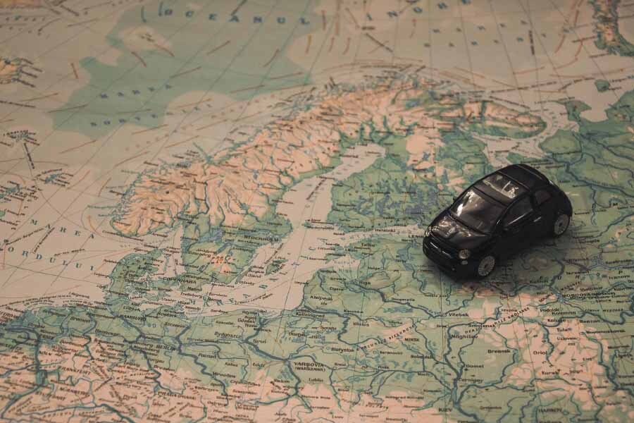 A map and a car symbolizing travel planning and vacation tips.