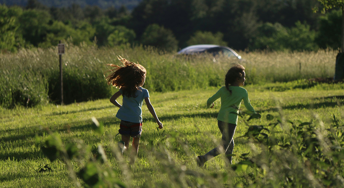 TChildren running outdoors, illustrating how kids can quickly move out of sight