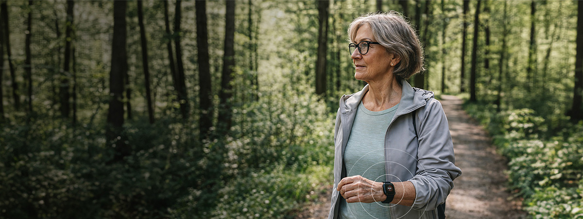 Woman in the forest wearing MiniFinder Watch with black wristband
