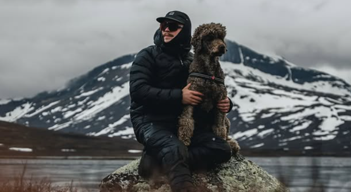 Dog and owner hiking together in the mountains during an outdoor hike