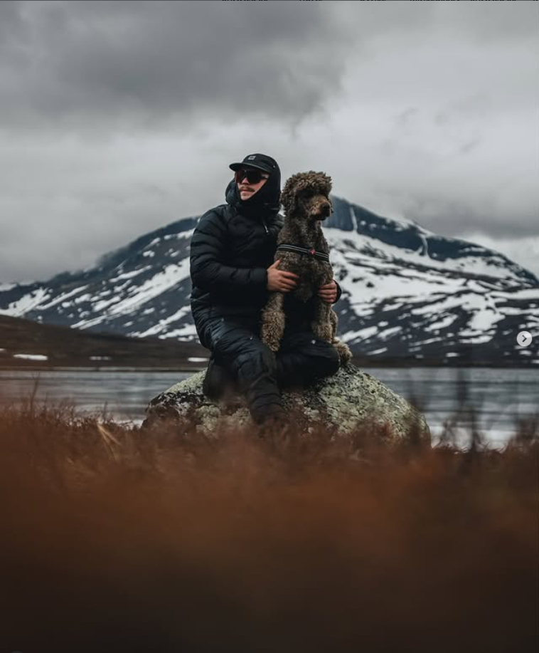 Dog and owner hiking together in the mountains during an outdoor hike