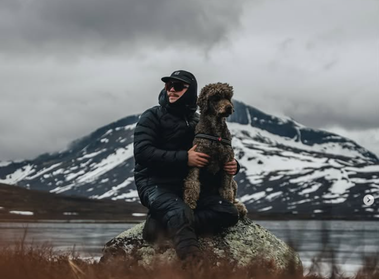Dog and owner hiking together in the mountains during an outdoor hike